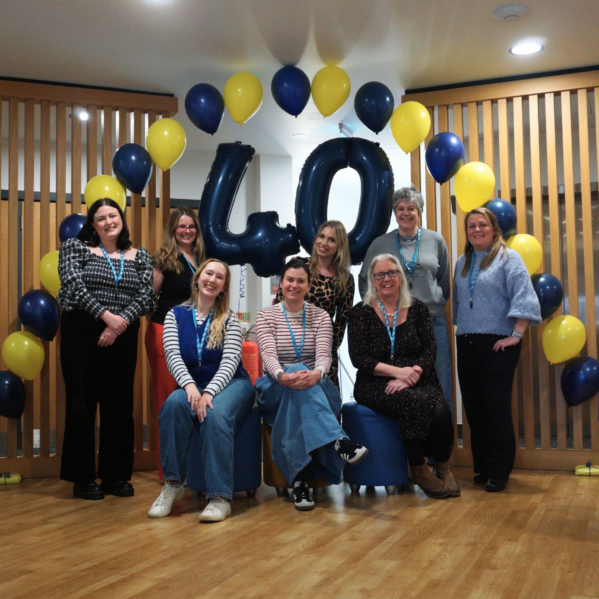 charity team in front of blue and yellow balloons
