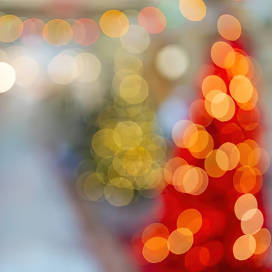 one red and one green christmas tree out of focus