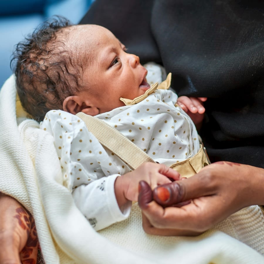 Newborn baby being held by mother