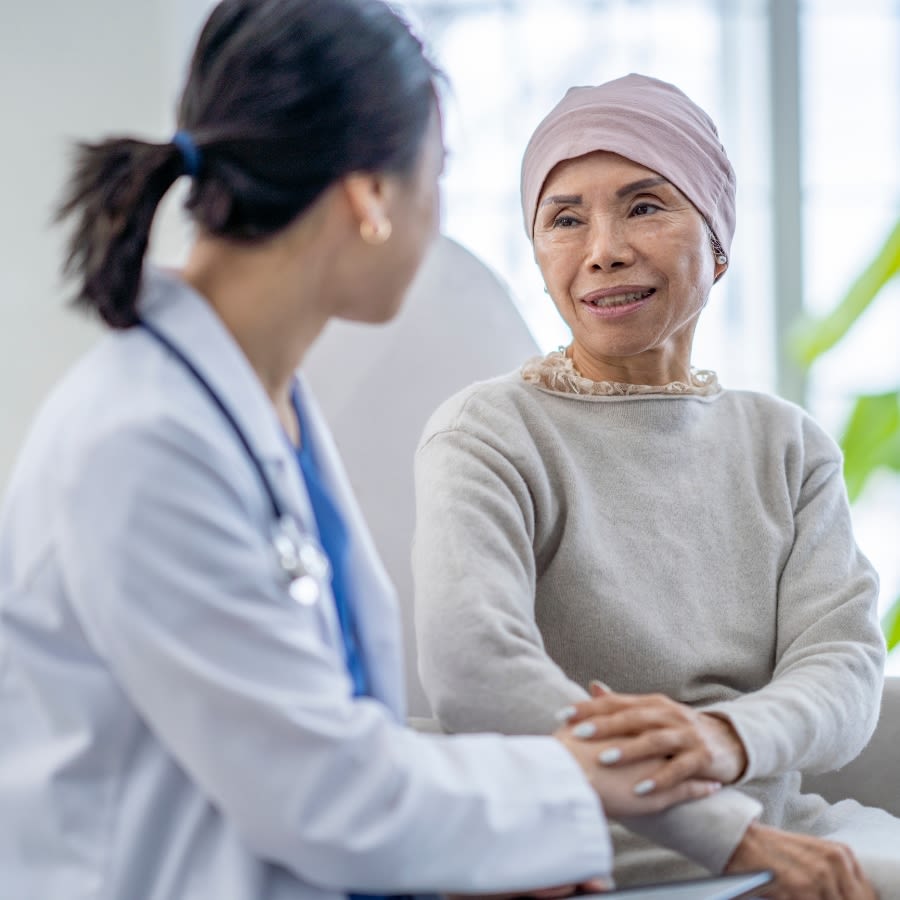 Cancer patient being comforted by a medical professional