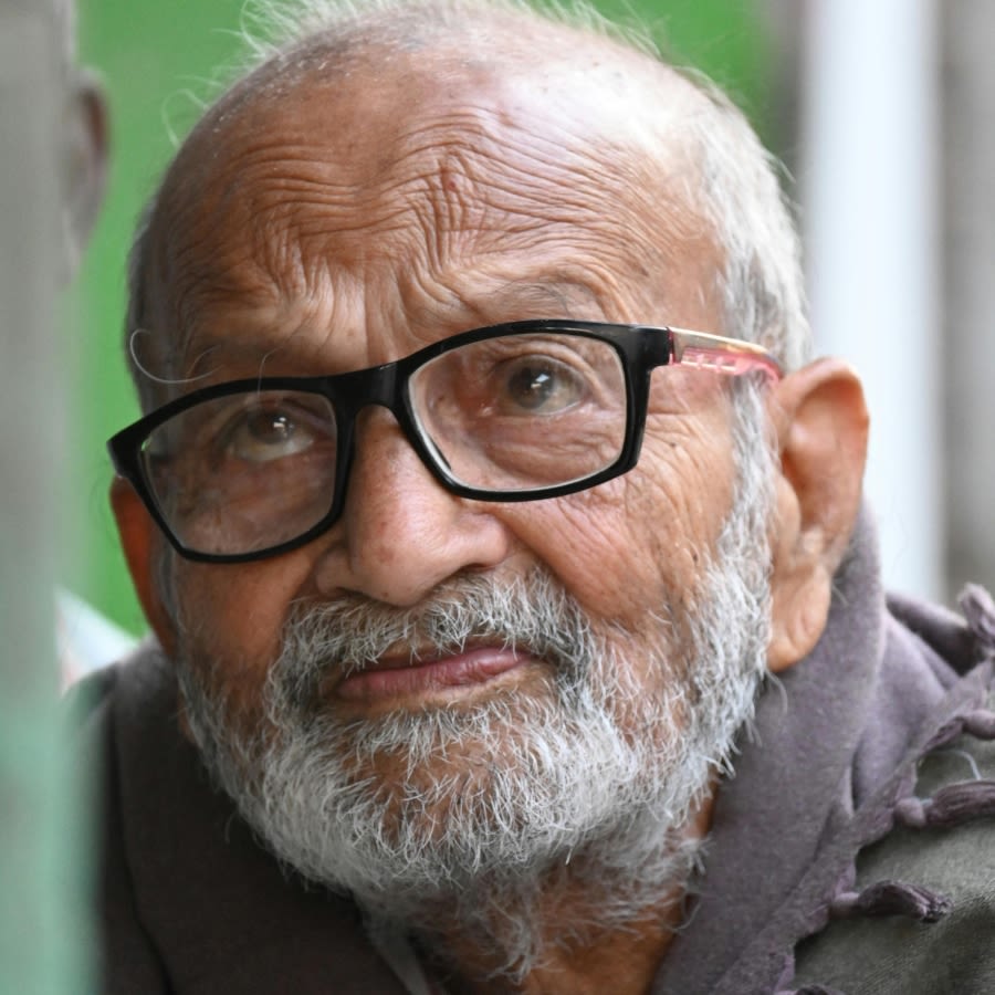 Older gentleman wearing glasses looking up solumnly
