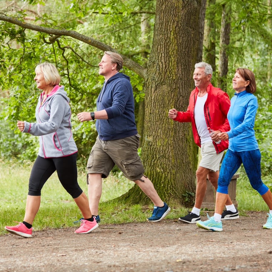 Group of four people walking in a park