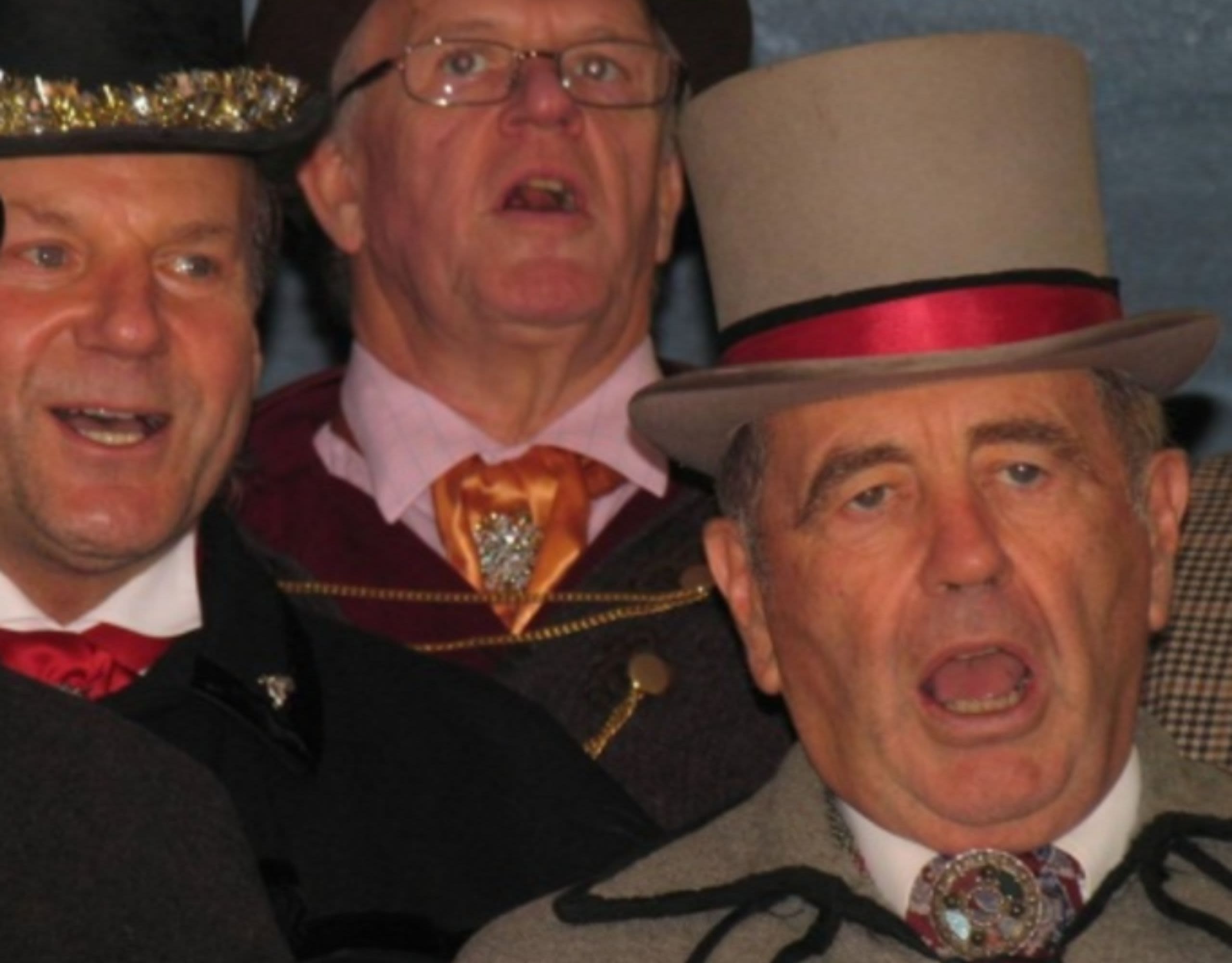 Close up of a few members of the Owls of Pill singing