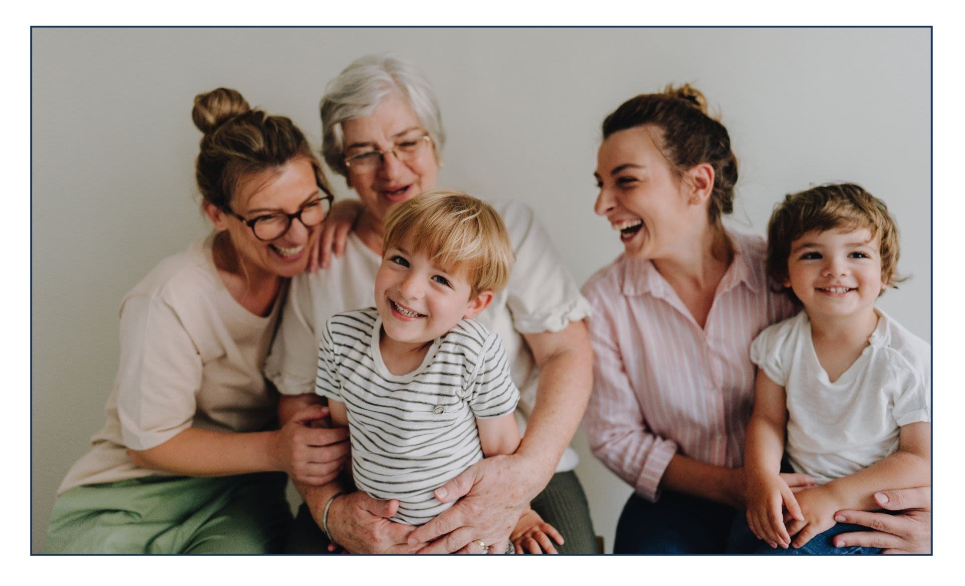 Three generations of a family, with a grandmother, mothers, and grandsons cuddling